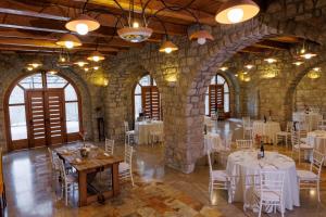 a room with white tables and chairs in a building at Le Conche country house in Villamaina