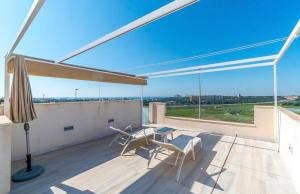 a patio with a table and chairs on a balcony at Casa Phillips in Orihuela Costa