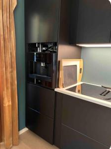 a small kitchen with a microwave in a kitchen at Marits residense in Kongsberg