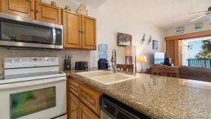 a kitchen with a sink and a microwave at Laughing Seagull Lovely Oceanfront Condo in Puerto Peñasco