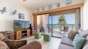a living room with a view of the ocean at Laughing Seagull Lovely Oceanfront Condo in Puerto Peñasco