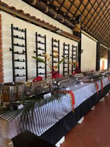 a long table with flowers on top of it at Malokas Resort - El Socorro - San Gil in Socorro