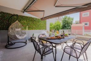 a patio with a table with chairs at Exclusive Apartment MARIJA in Strožanac
