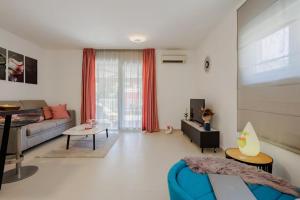 a living room with a couch and a table at Exclusive Apartment MARIJA in Strožanac