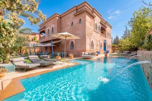 a home with a swimming pool in front of a house at Luxury Private Villa Taj Sofia & Spa in Marrakesh
