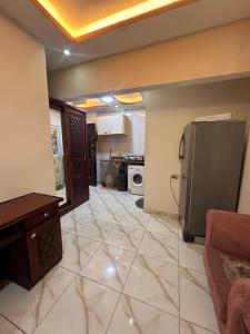 a large room with a kitchen with a refrigerator at Village chalet in Petra