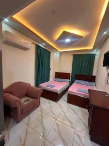 a living room with two beds and a couch at Village chalet in Petra