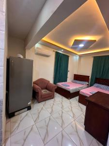 a room with two beds and a tv in it at Village chalet in Petra