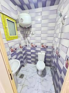 a bathroom with a toilet and a sink at Village chalet in Petra