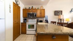 a kitchen with a counter top and a stove top oven at Laughing Seagull Lovely Oceanfront Condo in Puerto Peñasco +19 photos
