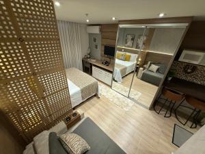 a hotel room with a bed and a mirror at Flat Completo Granja Brasil in Petrópolis