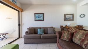 a living room with a couch and a table at Laughing Seagull Lovely Oceanfront Condo in Puerto Peñasco