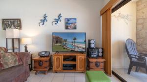 a living room with a tv and a couch at Laughing Seagull Lovely Oceanfront Condo in Puerto Peñasco
