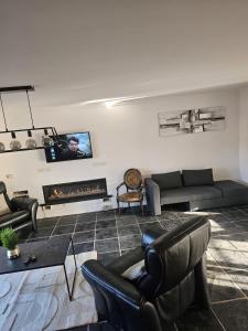 a living room with a couch and a fireplace at Vacation at Emi's in Wetteren