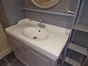 a bathroom with a white sink in a room at Vacation at Emi's in Wetteren +55 photos