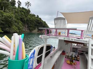 a boat with chairs and a bar on the water at Vibe in Paraty +2 photos