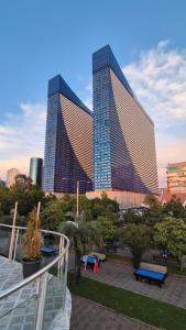 a large building with two tall skyscrapers in a city at VIP HOTEL Sea view in batumi R in Batumi