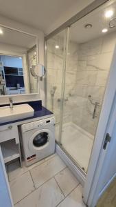 a bathroom with a shower and a washing machine at VIP HOTEL Sea view in batumi R in Batumi +24 photos