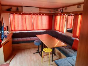 a living room with a table and a couch at mobile home in Bielle