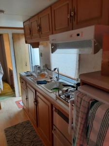 a kitchen with a sink and a stove top oven at mobile home in Bielle