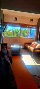 a bedroom with a bed and two windows in a room at Altocostanera in Posadas