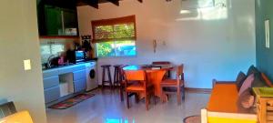 a kitchen with a table and chairs in a room at Altocostanera in Posadas