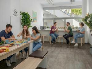 a group of people sitting around a table playing a board game at UrbanKey Studios - Vienna Neubau in Vienna