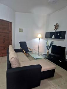 a living room with a couch and a glass table at Central 1 BR Retreat in Il-Gżira
