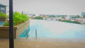 a large swimming pool on top of a building at Syafiq Suite in Kota Bharu