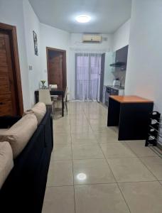 a living room with a couch and a table at Central 1 BR Retreat in Il-Gżira +10 photos