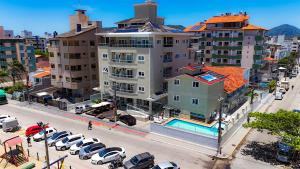 an aerial view of a city with cars parked in a parking lot at Pousada Roberto Monteiro - Frente Mar in Florianópolis