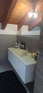 a bathroom with a sink and a wooden ceiling at Luna di miele in Albosaggia +44 photos
