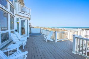 a balcony with rocking chairs and the beach at 4000 - Fragile Magic in Kitty Hawk