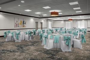 a banquet hall with white tables and green bows at Hilton Garden Inn Fort Worth Medical Center in Fort Worth +35 photos