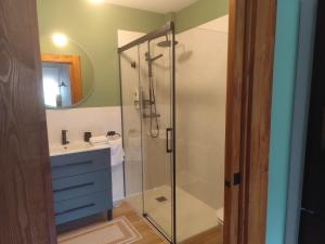 a bathroom with a glass shower and a sink at El Sueño de Celia 1 in Doña Juandi +5 photos
