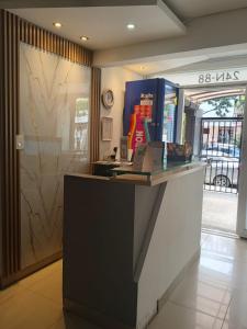 a lobby of a store with a reception desk at Hotel pasarela real cali in Cali