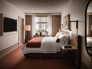 a hotel room with a large bed and a window at The Huntington Hotel in San Francisco +27 photos