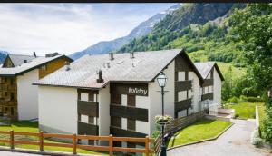 a hotel with a mountain in the background at Holiday Leukerbad Ruhe Natur Berge Free Parking 80 in Leukerbad