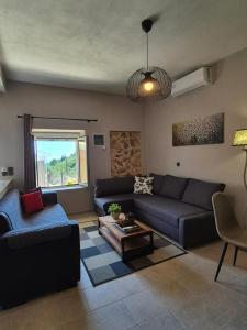 a living room with a couch and a table at Sogno 2 in Parga +43 photos