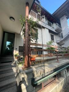 a house with a porch with a swing at MONTECAMPI casa di charme in Meda