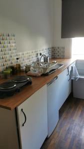 a kitchen with a sink and a counter top at Résidence Castors Colombes in Colombes +5 photos