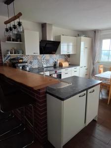 a kitchen with white cabinets and a black counter top at Bed&Breakfast bei Sabine in Leutschach
