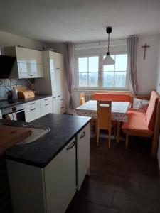 a kitchen and living room with a table and a dining room at Bed&Breakfast bei Sabine in Leutschach