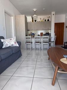 a living room with a couch and a table at J&J spacious balcony apartment in Preveza