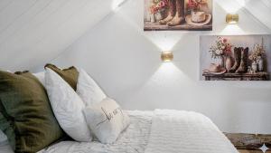 a bedroom with a bed with white sheets and green pillows at Valley View Hideaway Cabin with Mountain Views in Miramonte
