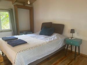 a bedroom with a bed with two towels on it at Jonathans Cabins in Utila