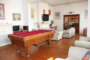 a living room with a pool table in it at Alpine Heritage Motel in Goulburn