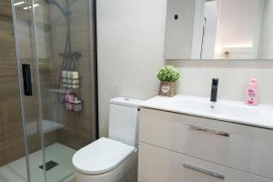 a bathroom with a toilet and a sink and a shower at Casita Romántica con Suite y Bañera en la Sierra "Colladito de Alce" in Collado Hermoso