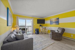a living room with a couch and two chairs and a table at Beach, Please! Oceanfront, Balcony & Sunrise Views in North Topsail Beach +42 photos