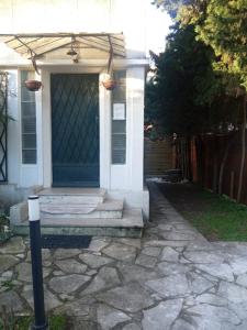 a house with a blue door and a stone walkway at Résidence Castors Colombes in Colombes